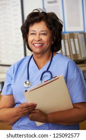 Female Nurse At Nurses Station