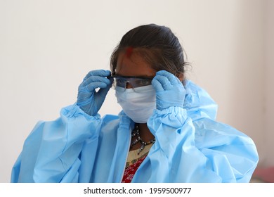 A Female Nurse Putting On Her Protective Glasses And Getting Ready For The Start Of Her Work