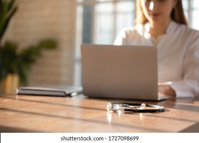 Female Nurse Sit At Wooden Desk In Private Clinic Working On Laptop Consulting Client Online, Woman Doctor Or General Practitioner Busy Texting And Typing On Computer, Stethoscope Lying On Table