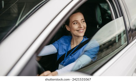 Female nurse sitting in car, going home from work. Female doctor driving car to work, on-call duty. Work-life balance of healthcare worker.