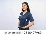 A female nurse is standing wearing scrubs and a stethoscope. He is smiling and looking camera.Portrait of young female nurse isolated on white