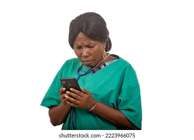 Female Nurse With Stethoscope Standing On White Background Looking At Mobile Phone Nervous.