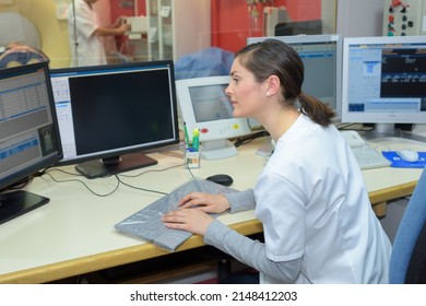 Female Nurse Working On Computer At Hospital Reception