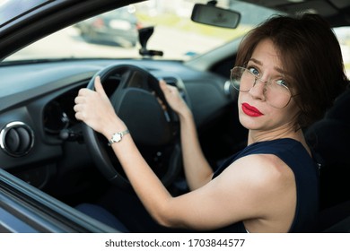 Female in office suit ariives at work by car and need to help
