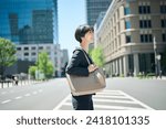 Female office worker in her 30s walking in the business district