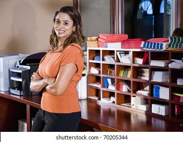 Female Office Worker, Indian Ethnicity, Standing In Mailroom With Office Equipment