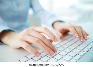 Female office worker typing on the keyboard - Shutterstock ID 157537799