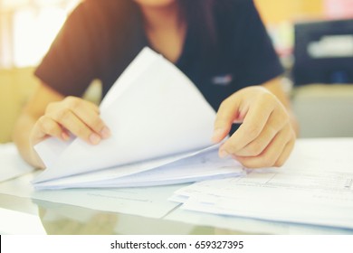 Female Office Workers Holding  Are Arranging Documents Of Unfinished Documents On Office Desk, Stack Of Business Paper.