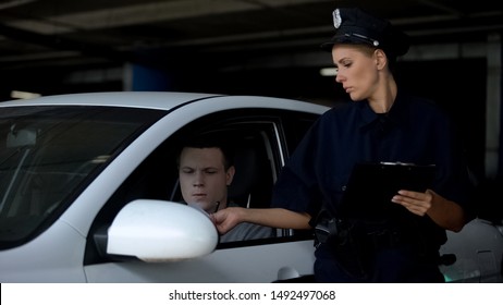 Female Officer Giving Traffic Ticket To Male Driver For Parking Violation, Fine