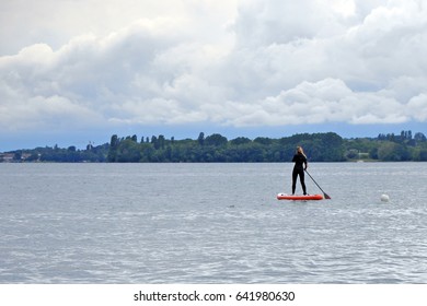  female on paddle board floating in the blue sea