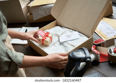 Female Online Store Small Business Owner Seller Holding Gift Packing Package Post Shipping Box Preparing Delivery Parcel On Table. Ecommerce Dropshipping Holiday Presents Sale Concept. Closeup.