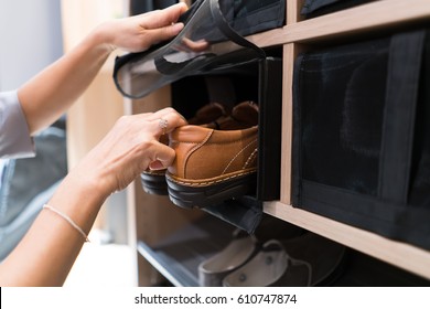 Female Open Net And Ake Off Brown Man Shoes In The Shoe Rack For Use, They Are Arrange And Neatly And Close Net Protect.
