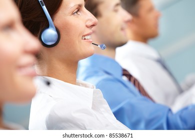 Female operator answering a call among her colleagues