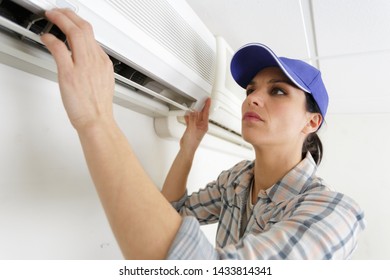 Female Operator Inspecting Air Conditioning