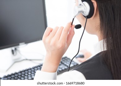 Female operator working on personal computer