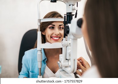 Female Optometrist Checking Patient's Vision At Eye Clinic. Healthcare And Medical Concept.