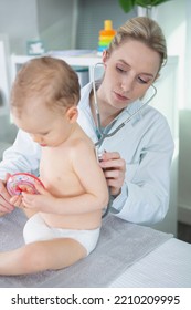 Female Paediatrician Holding Stethoscope On Infants Back