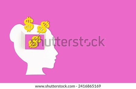 Female paper head isolated on pink background. Golden dollar signs spill through the open window in the brain area. Mindful spending habits concept.