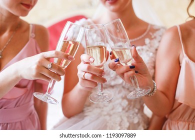 Female Party With Glasses Of Champagne On The Bed. Witnesses And Fiancee Drink Champagne