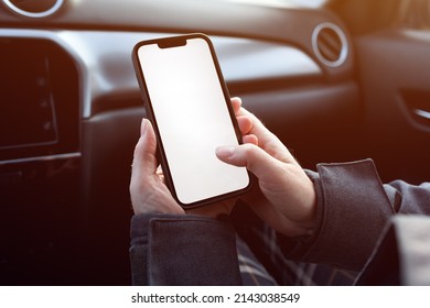 Female Passenger In The Car Using Mobile Phone With Blank White Screen As Mockup Copy Space, Selective Focus