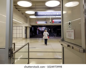 Female Passenger Exits Terminal Through Security Checkpoint At Philadelphia International Airport
