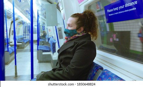 Female Passenger Wearing Face Covering Mask During Covid-19 Lockdown Inside Metro Train In England Uk