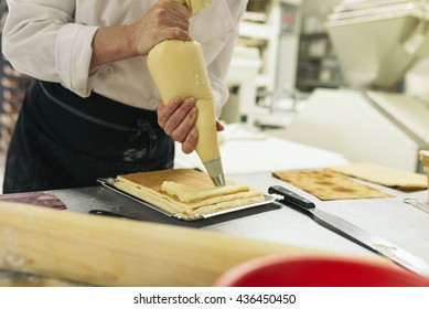 Female pastry chef decorating dessert in the kitchen. Cooking Concept. - Shutterstock ID 436450450