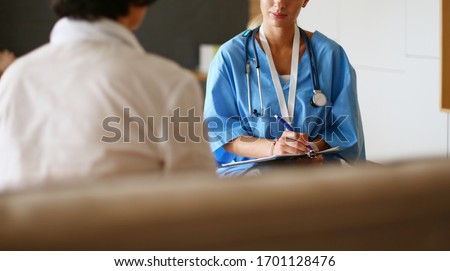 Similar – Doctor giving a prescription to senior patient