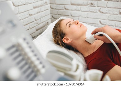 Female Patient Getting Thyroid Ultrasound Exam In Hospital