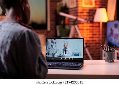 Female Patient Having Online Appointment With Therapist, Telehealth Service Concept. Woman Talking With General Practitioner On Videocall In Room With Modern Interior, Back View