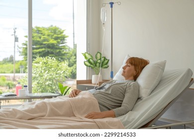 Female patient laying in IV fluid in the hospital. - Powered by Shutterstock