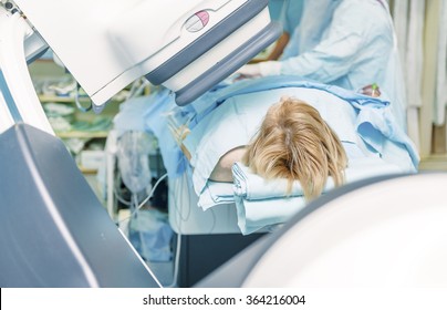 A female patient on a cath lab table durring catheterisation