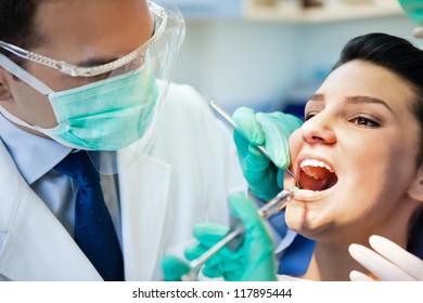 Female Patient With Open Mouth Receives An Injection At The Dentist