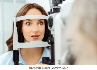 Female patient in ophthalmology clinic checking her eyesight. Medical examination - Powered by Shutterstock