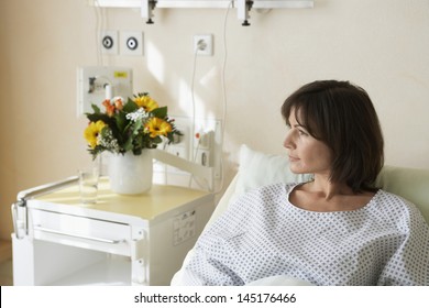 Female Patient Resting In Hospital Bed