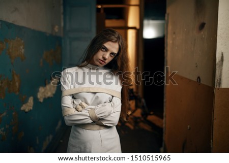 Female patient in strait jacket, mental hospital