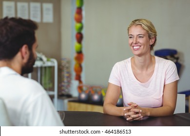 Female Patient Talking To Male Therapist In Clinic