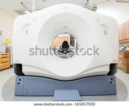 Female patient undergoing CT scan test in examination room
