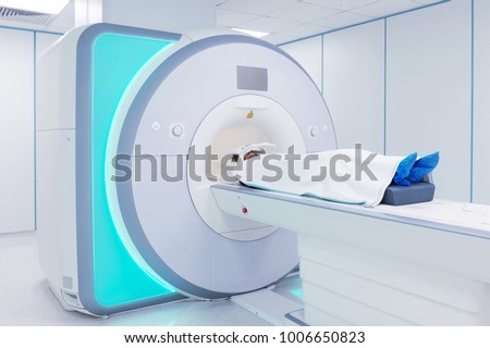 Female patient undergoing MRI - Magnetic resonance imaging in Hospital. Medical Equipment and Health Care.

