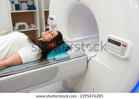 Female patient undergoing MRI - Magnetic resonance imaging in Hospital. Medical Equipment and Health Care