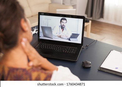 Female Patient In A Video Call With Doctor Talking About Her Neck Injuri.