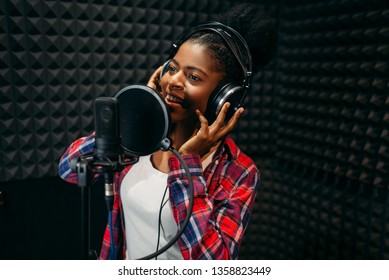 Female performer songs in audio recording studio - Powered by Shutterstock