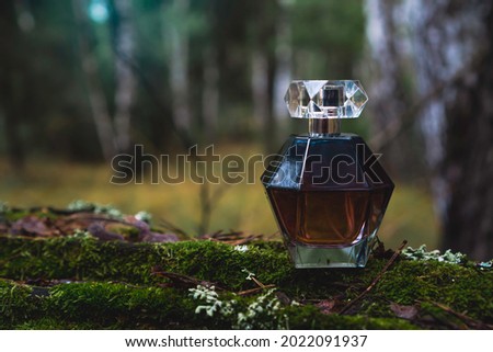 Female perfume bottle at the pine forest.