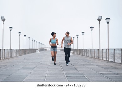 Female person, man and running outdoor for fitness, exercise and happy for marathon training. Athlete, personal trainer and cardio or race in nature for workout, wellness or competition in California - Powered by Shutterstock