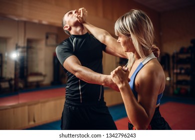 Female person on self-defense workout with trainer