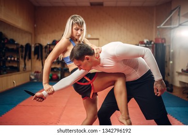 Female person practicing knee kick to the stomach - Powered by Shutterstock