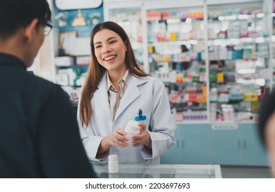 female pharmacist at drugstore.Health care pharmacists work at the hospital.Pharmacist looking at male customer.Doctor specialists organize prescription medications. - Shutterstock ID 2203697693