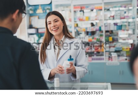 female pharmacist at drugstore.Health care pharmacists work at the hospital.Pharmacist looking at male customer.Doctor specialists organize prescription medications.