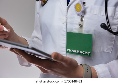 Female Pharmacist Using Electronic Medical Record For Patient Care. Up Close Of Medical Professional Using Tablet. Tech In Health Care. Healthcare Technology.