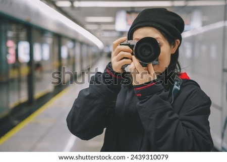 Female Photographer Capturing Moments in Subway